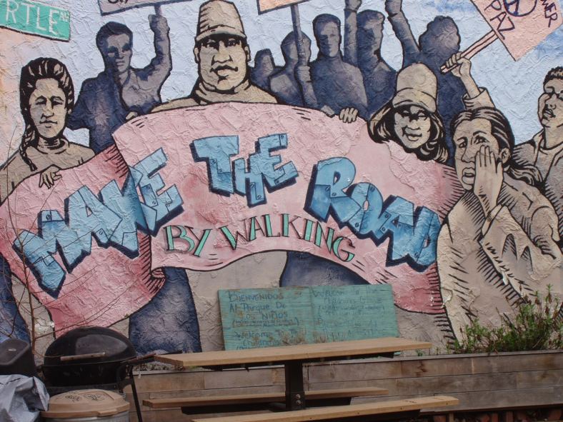 A mural painting on a wall along Myrtle Avenue, beneath the M train.